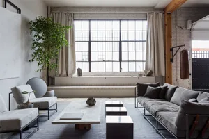 Industrial living room featuring concrete and wood elements.