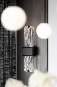 Modern interior design featuring a glass lighting module installed on a dark wooden wall.