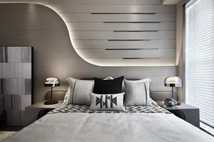 A modern bedroom featuring a large platform bed with metal frame and wood headboard, complemented by a sleek geometric headbo