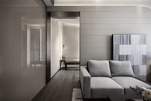 A modern living room with a gray sofa and minimalist decor.