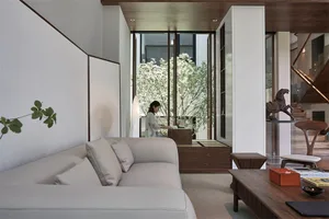 A modern living room featuring wood and textile elements