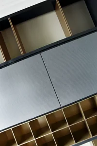 A modern minimalist closet with fabric-covered drawers and organizers.