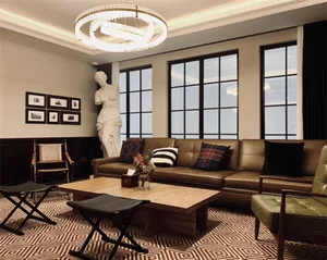 A living room with a leather sofa and wooden coffee table, featuring industrial design elements such as exposed metal beams a