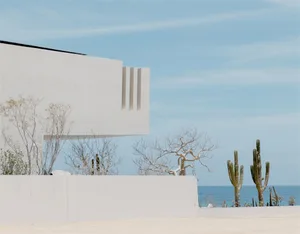 Modern architectural design featuring a minimalist, white, concrete structure