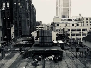Urban rooftop with industrial equipment and buildings.