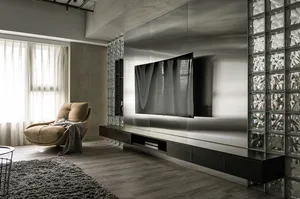 A modern living room with a glass wall and a minimalist chair.