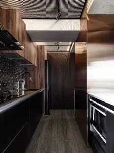 A modern minimalist kitchen with wood accents and dark wooden cabinets.