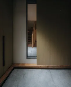 A view of a modern staircase featuring wooden paneling, seen from the top.