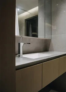 Modern minimalist bathroom featuring a concrete countertop and sink.