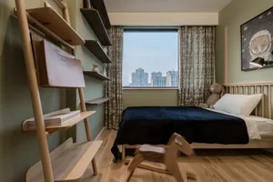 Modern bedroom featuring wooden shelves, minimalist decor, and a comfortable bed.