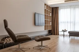 Modern living room featuring a leather recliner, walnut floor, and wooden shelving unit