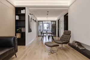 Modern living room with wood flooring and minimalist furniture.