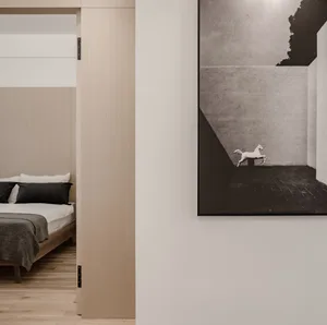 Minimalist bedroom with wood floor, concrete walls, and clean lines.