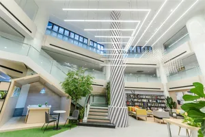 Modern office lounge with concrete and glass materials.