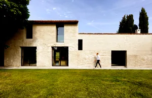 A modern residential home with a white stone and brick exterior.