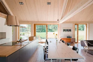 A contemporary residential kitchen featuring wood elements and large windows.