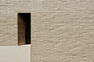 A modern exterior wall made of stone and brick.