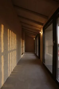 Modern interior with concrete walls and glass doors.