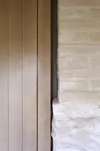 Modern interior design featuring natural wood paneling on walls and floors.