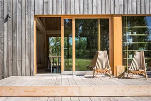 Modern, minimalist exterior of a residential home with wooden materials and clean lines.