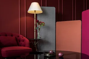 A modern living room with a red sofa, black table, and decorative elements.