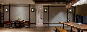 A contemporary dining room with mixed-media materials and design elements.