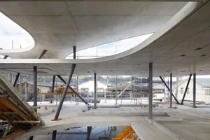 A construction site featuring modern concrete structures and scaffolding.