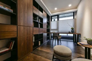 A modern contemporary home office with a wooden wall and floor, featuring a desk and chair setup.