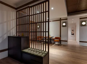 Modern residential space featuring wooden furniture and light fixtures.