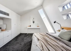 Modern white bedroom with concrete furniture and grey carpet