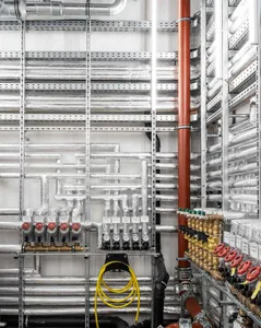 A detailed image of an industrial engineering space featuring metal structures and pipes.