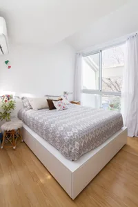 A minimalist bedroom featuring modern materials and design.