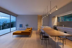 A modern interior design featuring concrete furniture and minimalist aesthetics.