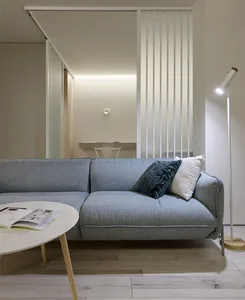 A modern living room with a neutral-toned sofa, round coffee table, and minimalist design.