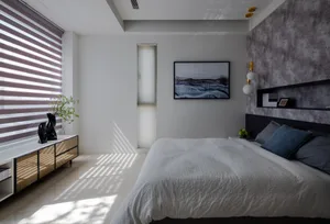 A modern bedroom featuring concrete walls and glass elements