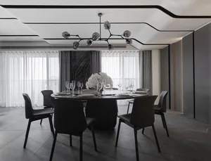 Modern dining room with glass table, metal chairs, and fabric seating