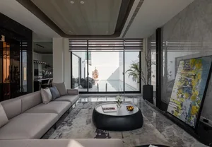 Modern living room with concrete, glass, and marble materials.