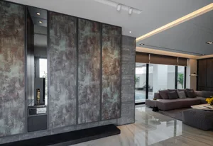 A modern living room featuring metallic panel walls and a sleek seating area.