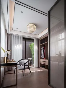 A modern luxury walk-in closet featuring a wooden floor, glass doors, and fabric drapes.