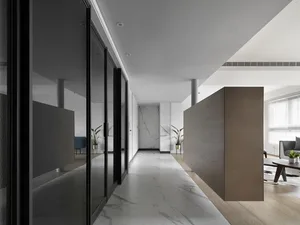 Modern, minimalist corridor featuring marble flooring and glass doors.
