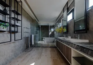 Modern bathroom with marble floor and glass walls