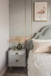 Modern bedroom featuring a brown upholstered bed and wooden nightstand.
