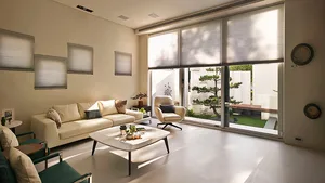 A modern living room featuring neutral colors and organic elements.