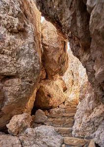 Rocky pathway through a cave entrance.