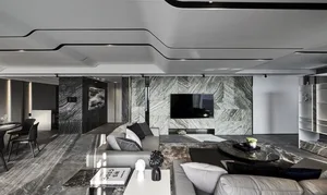 Modern living room featuring a marble accent wall and floor, with a white sofa and coffee table.