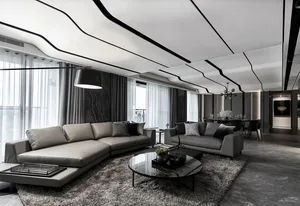 Modern minimalist living room featuring textured gray cement flooring, gray sofas, and an abstract black and white ceiling de
