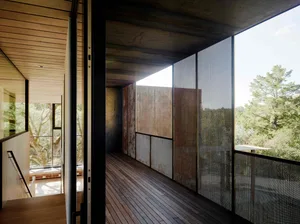 Modern interior space featuring wood, glass, metal, and concrete materials.