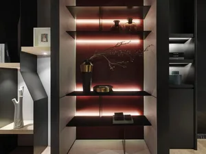 A modern metal shelf with red lighting and decorative branches.