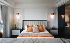 Modern bedroom featuring a contemporary design with a bed adorned with multiple cushions and blankets, situated within a room