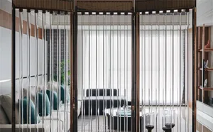 Modern living room featuring glass paneling and metal accents
